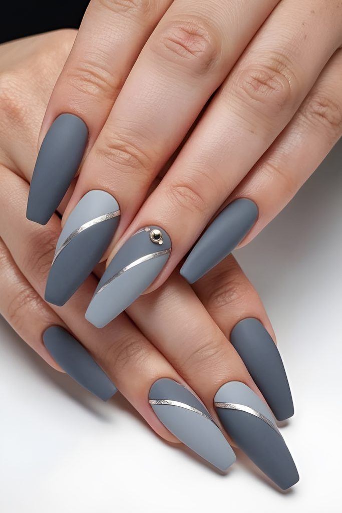 Spur Shaped Studs on Matte Gray Nails