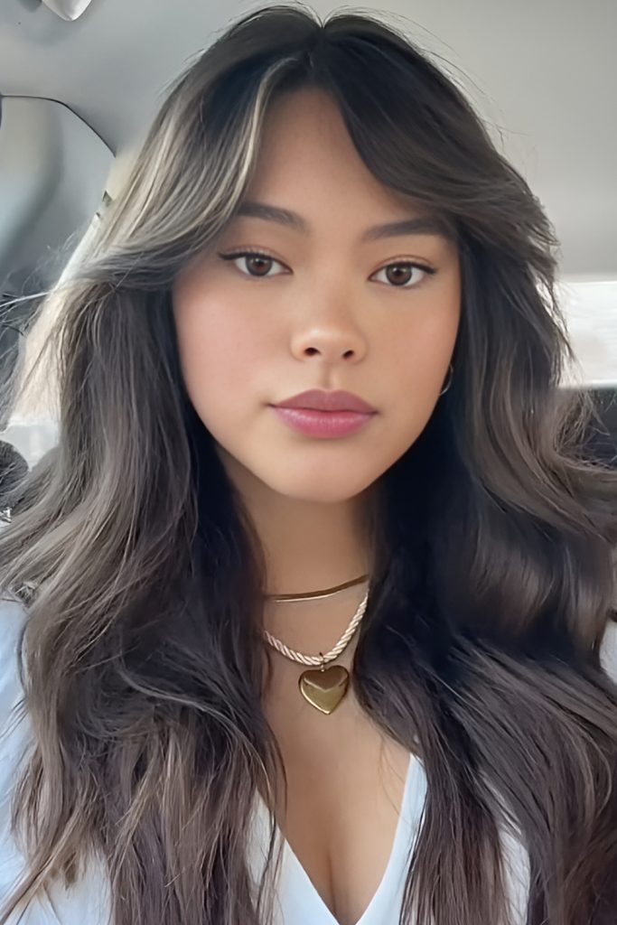 Curtain Bangs with a Deep Side Sweep for Drama