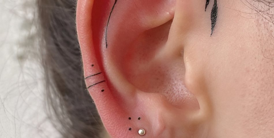 Layered Huggies with a Single Line Arrow Tattoo