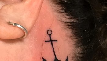 Stacked Stud Trios with a Fine Line Anchor Tattoo