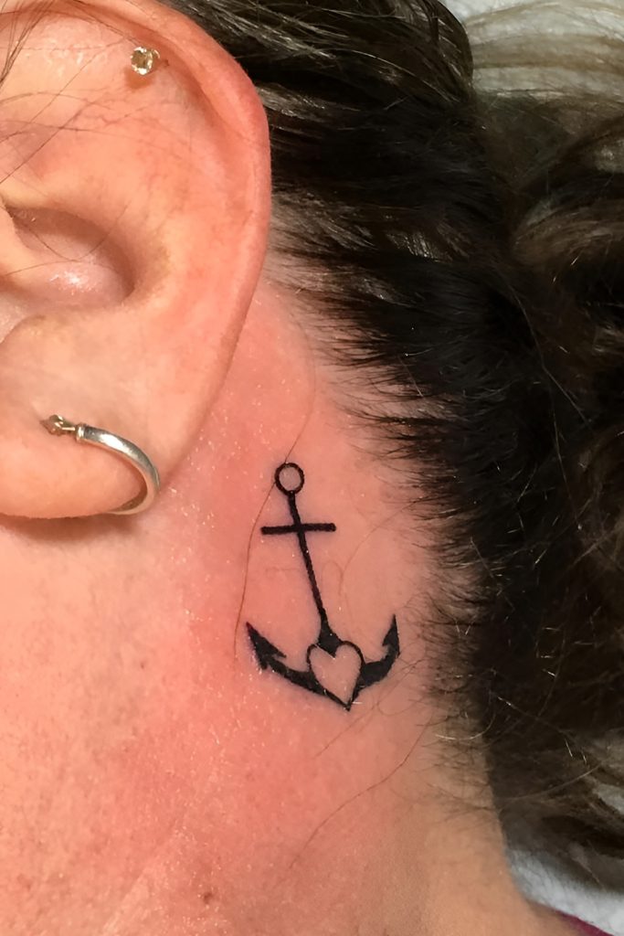 Stacked Stud Trios with a Fine Line Anchor Tattoo