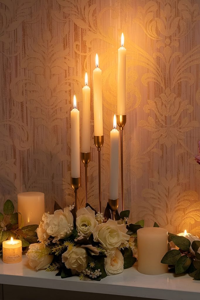Golden Candle Holders with Seasonal Greenery for a Warm Ambience
