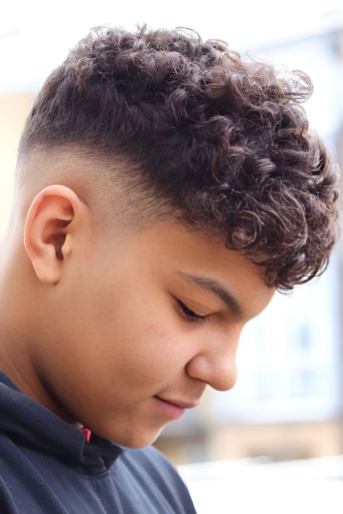 Messy Curly Top Paired With Low Fade Edges