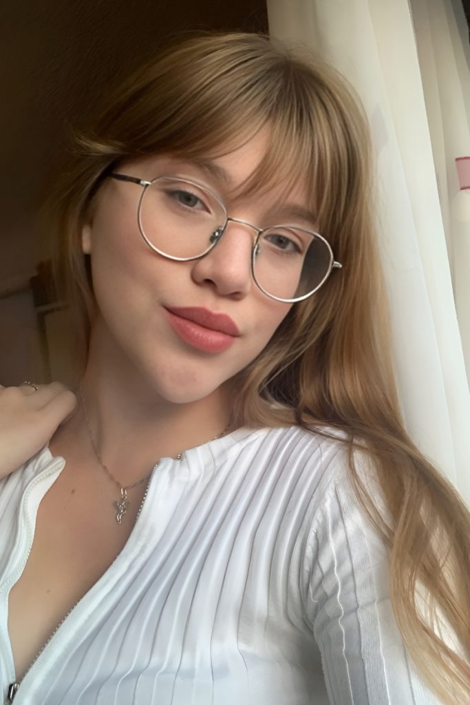 Long Straight Hair with Curtain Bangs That Tuck Behind Glasses