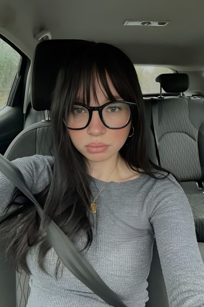 Long Straight Hair with Curtain Bangs and Black Frames