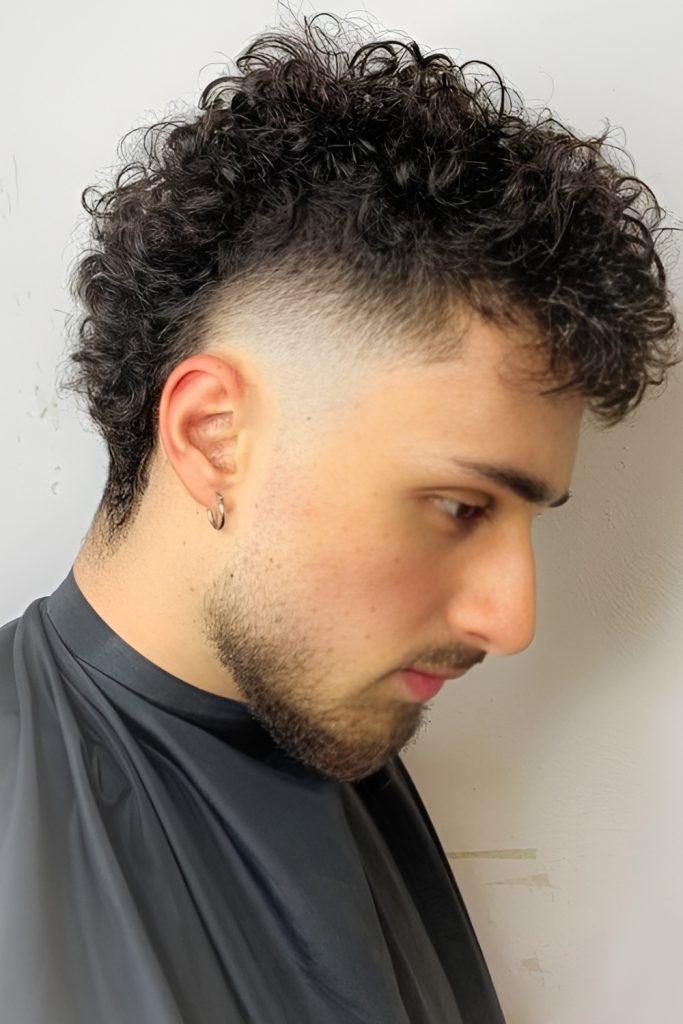 Bold Silhouette with a Short Curly Mohawk and Taper