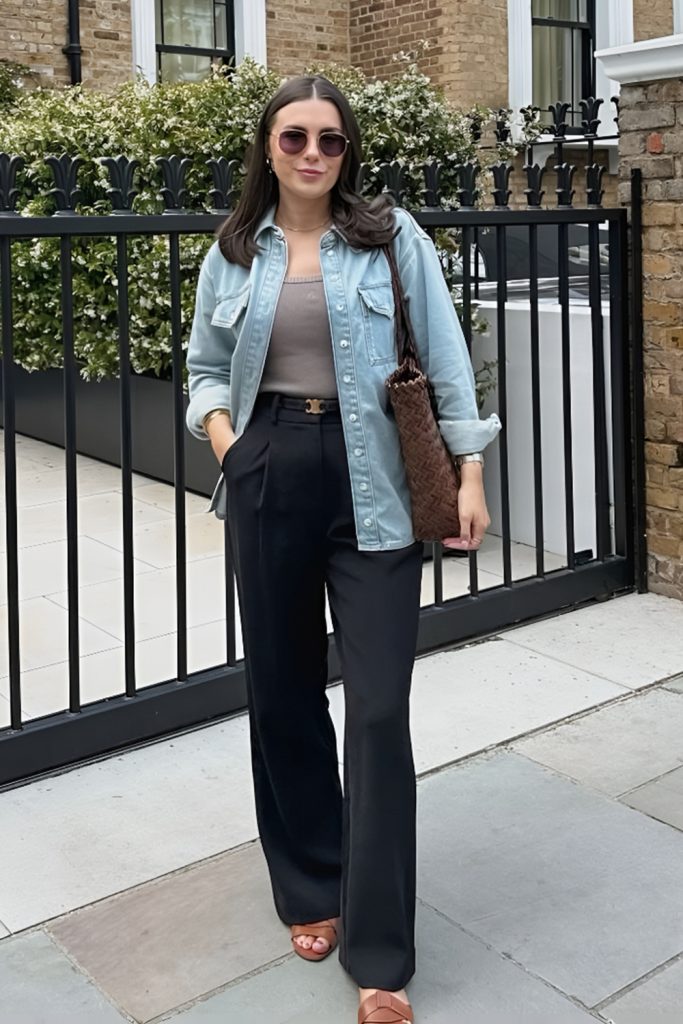 Pale denim overshirt with black trousers and a bag