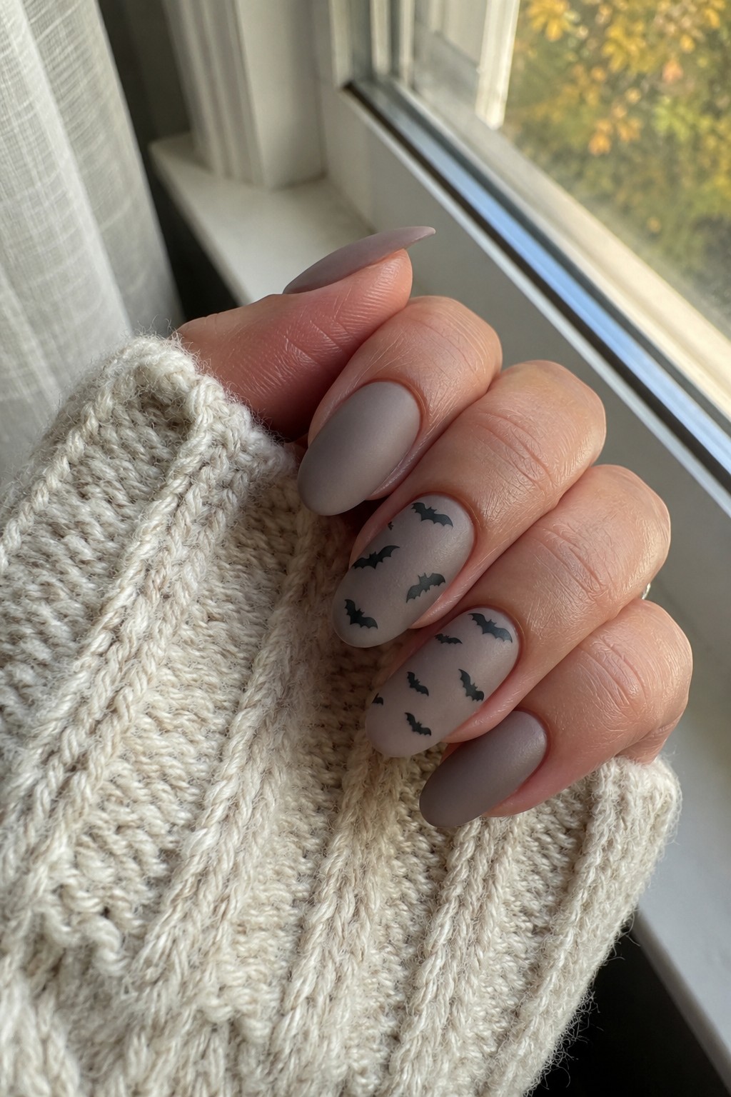 Pink base with bat accents Halloween nails