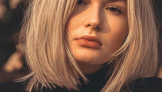 Woman with a textured choppy bob haircut in warm golden light