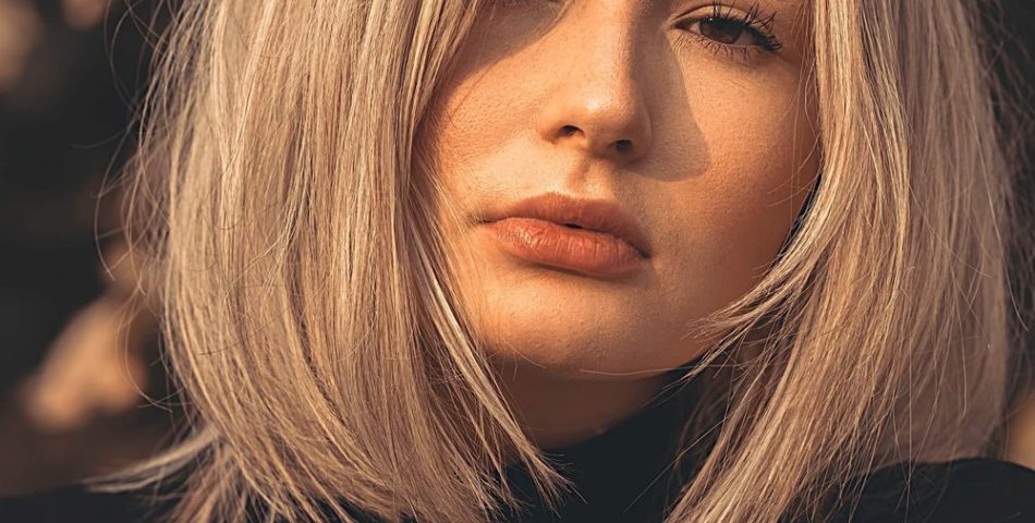 Woman with a textured choppy bob haircut in warm golden light