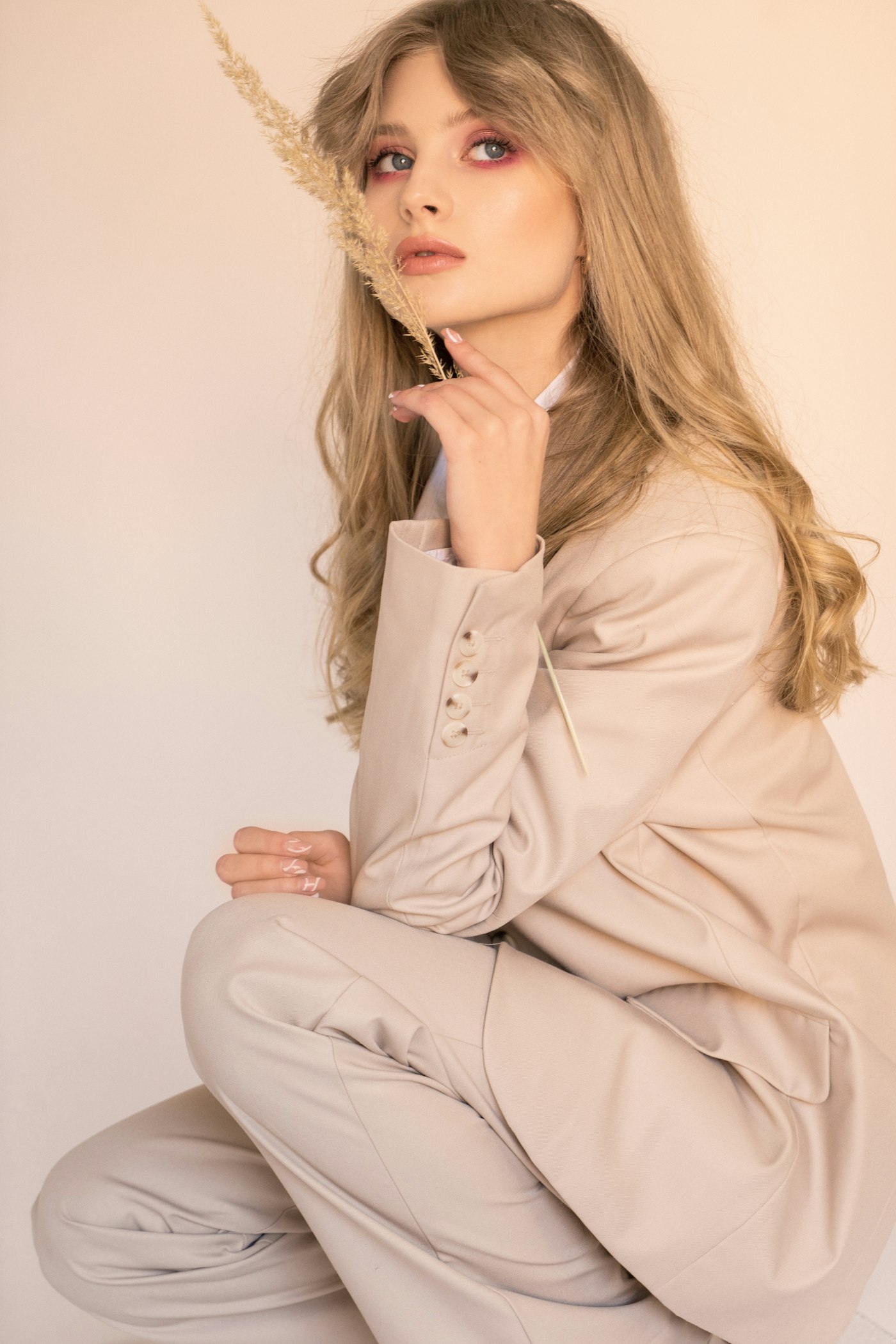 Young woman in a beige suit