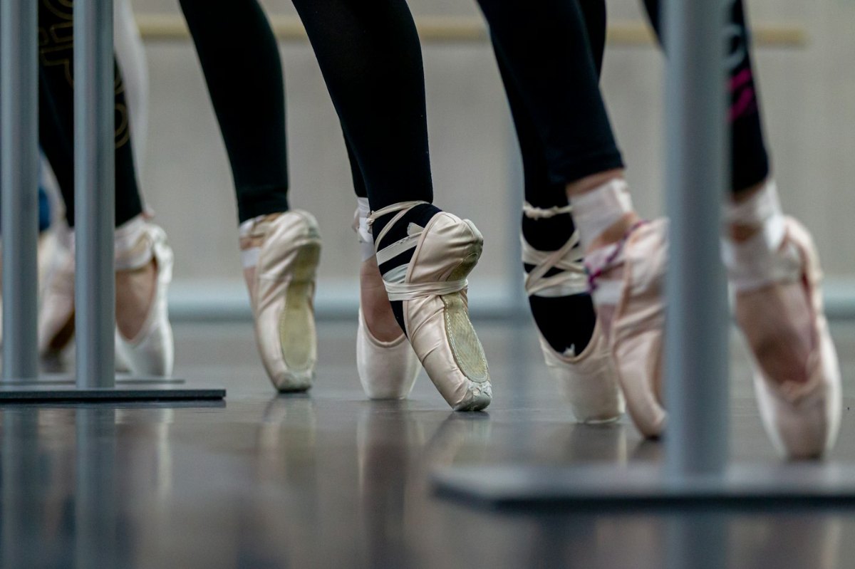 Pair of ballet shoes on a plain surface