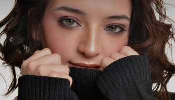 Woman in a black turtleneck sweater, the base of a turtleneck and leather skirt outfit