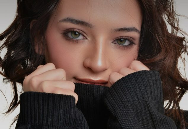 Woman in a black turtleneck sweater, the base of a turtleneck and leather skirt outfit