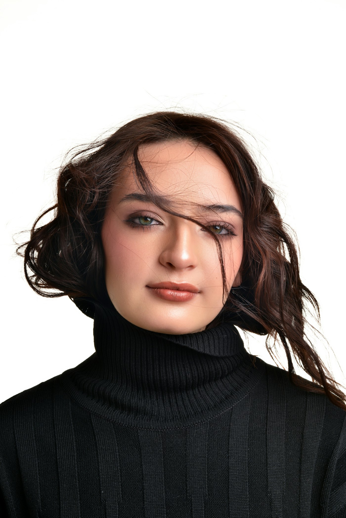 Young woman with dark hair wearing a black turtleneck