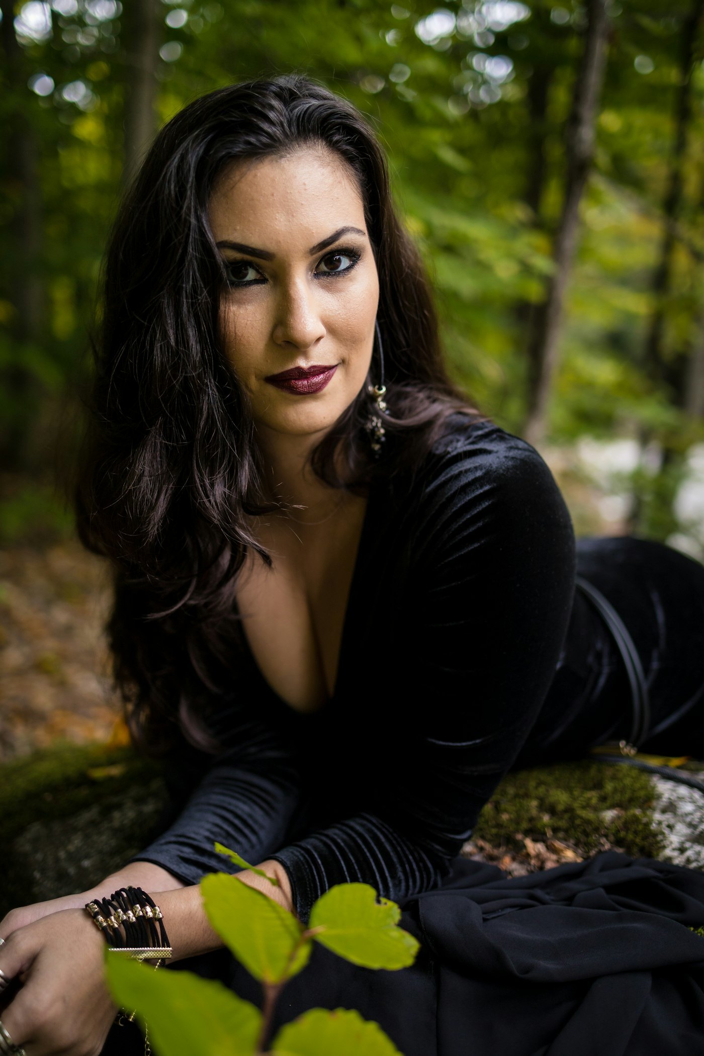Woman in a black velvet dress outdoors