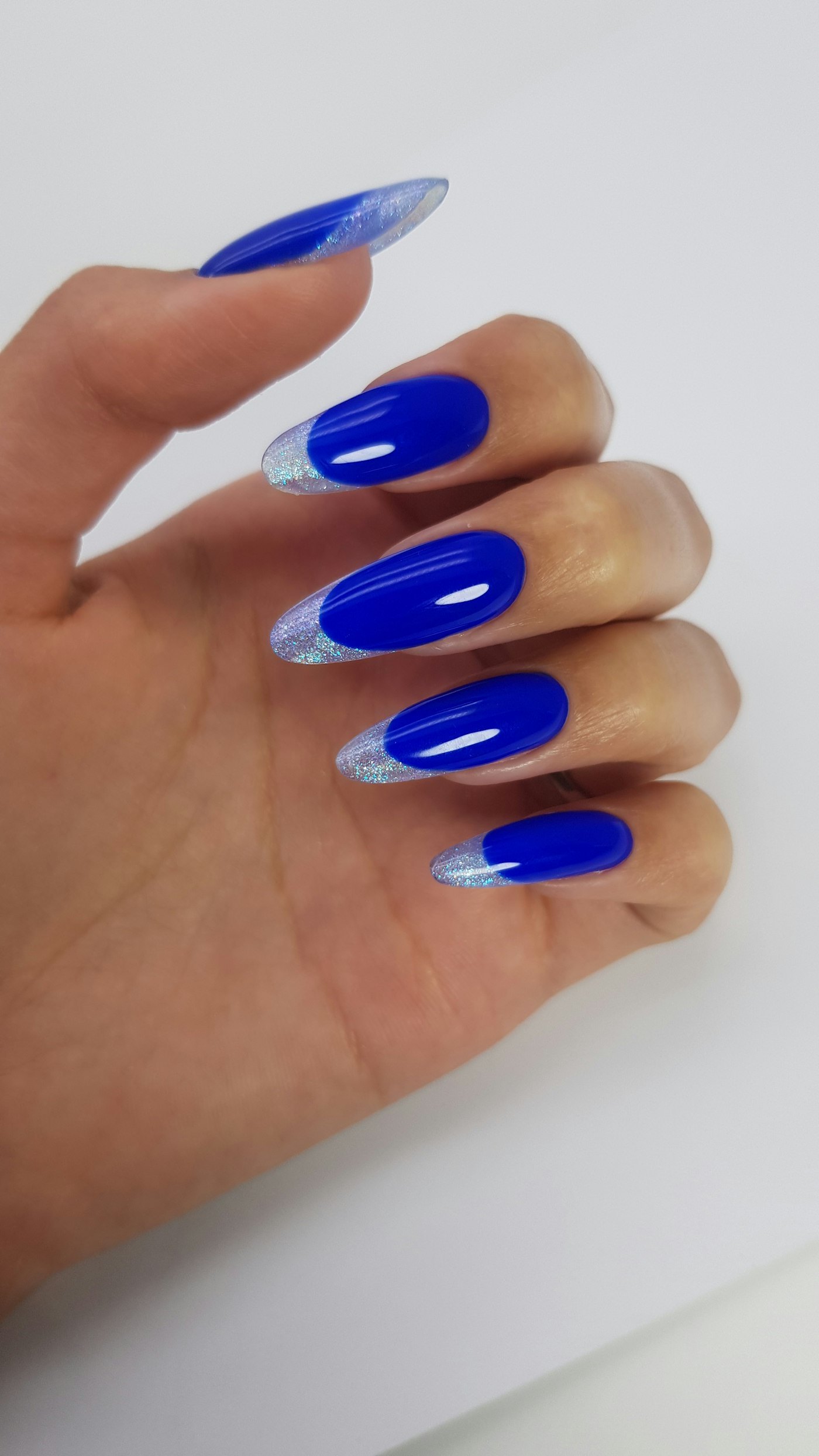 Blue almond shaped nails with silver french tips