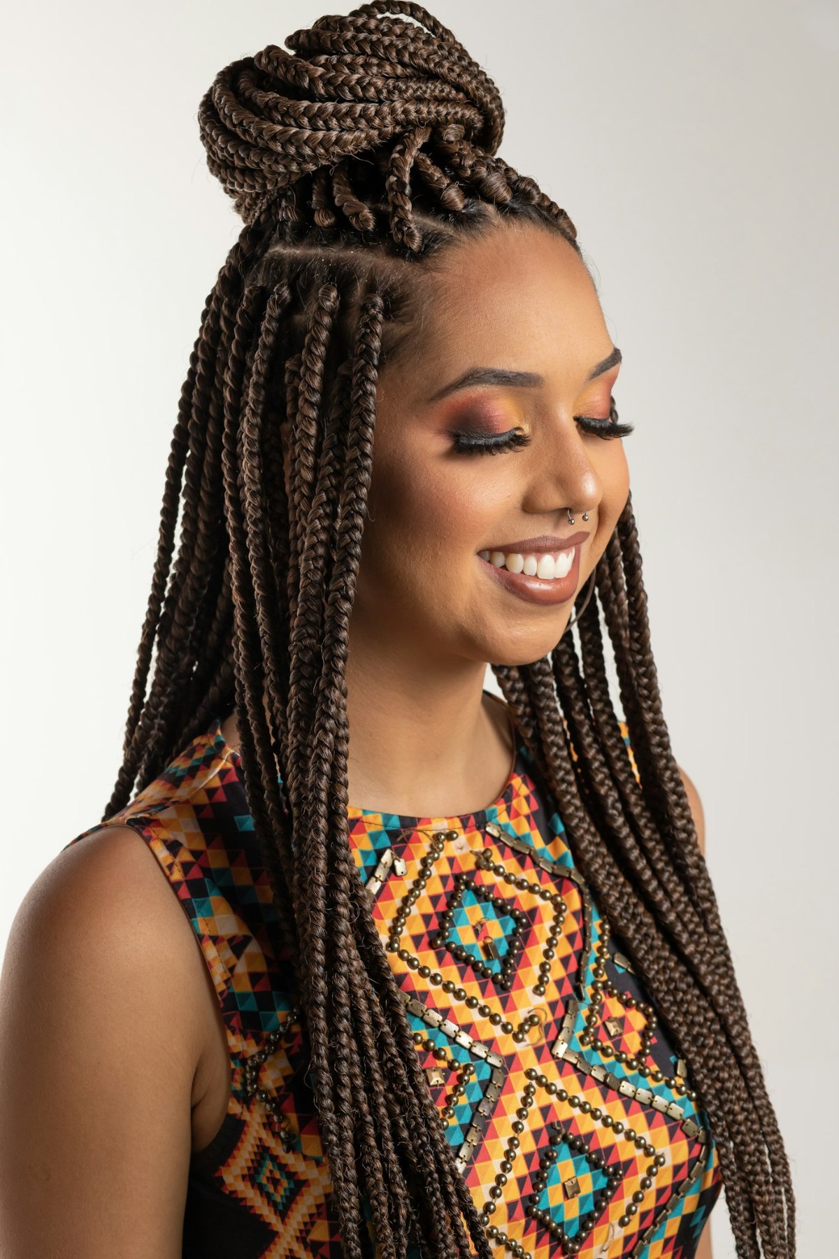 Woman with braided hair wearing a colorful blouse