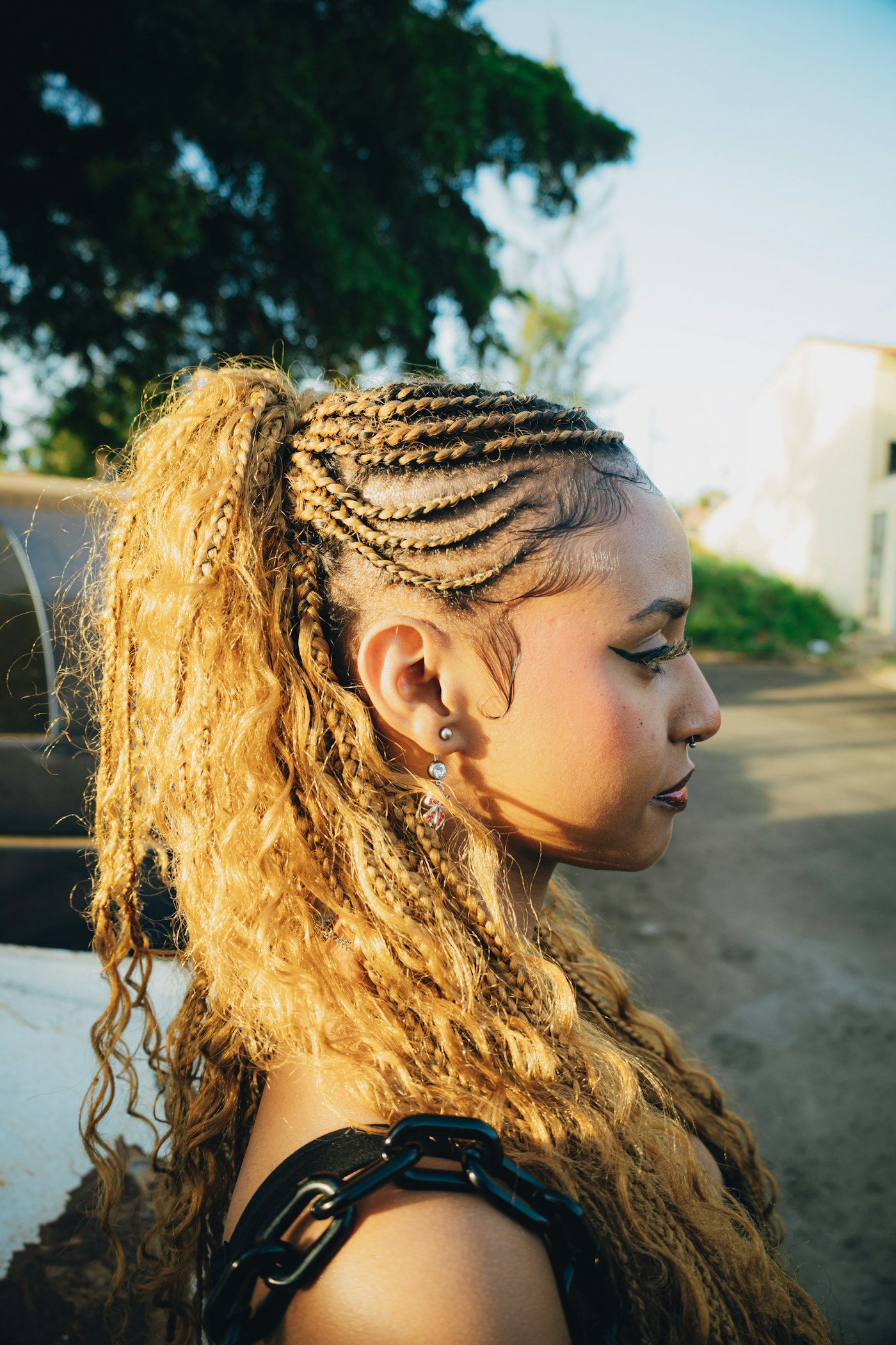 Woman with blonde braided hair and a ponytail outdoors