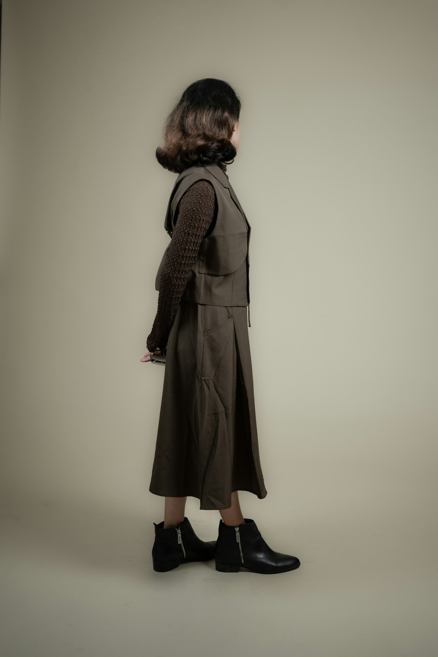 Woman in a brown dress and black boots
