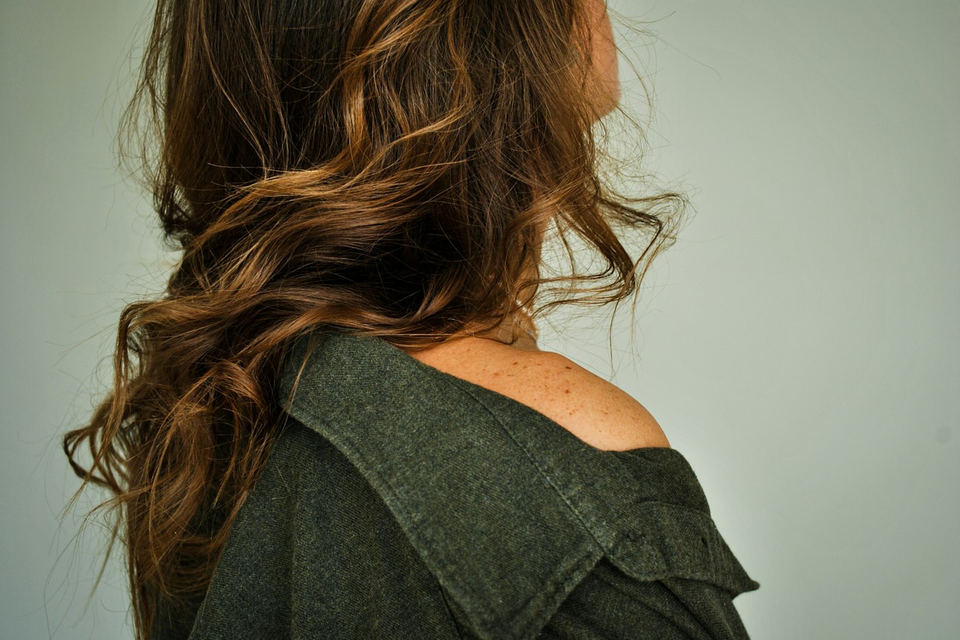 Woman with brown hair styled back