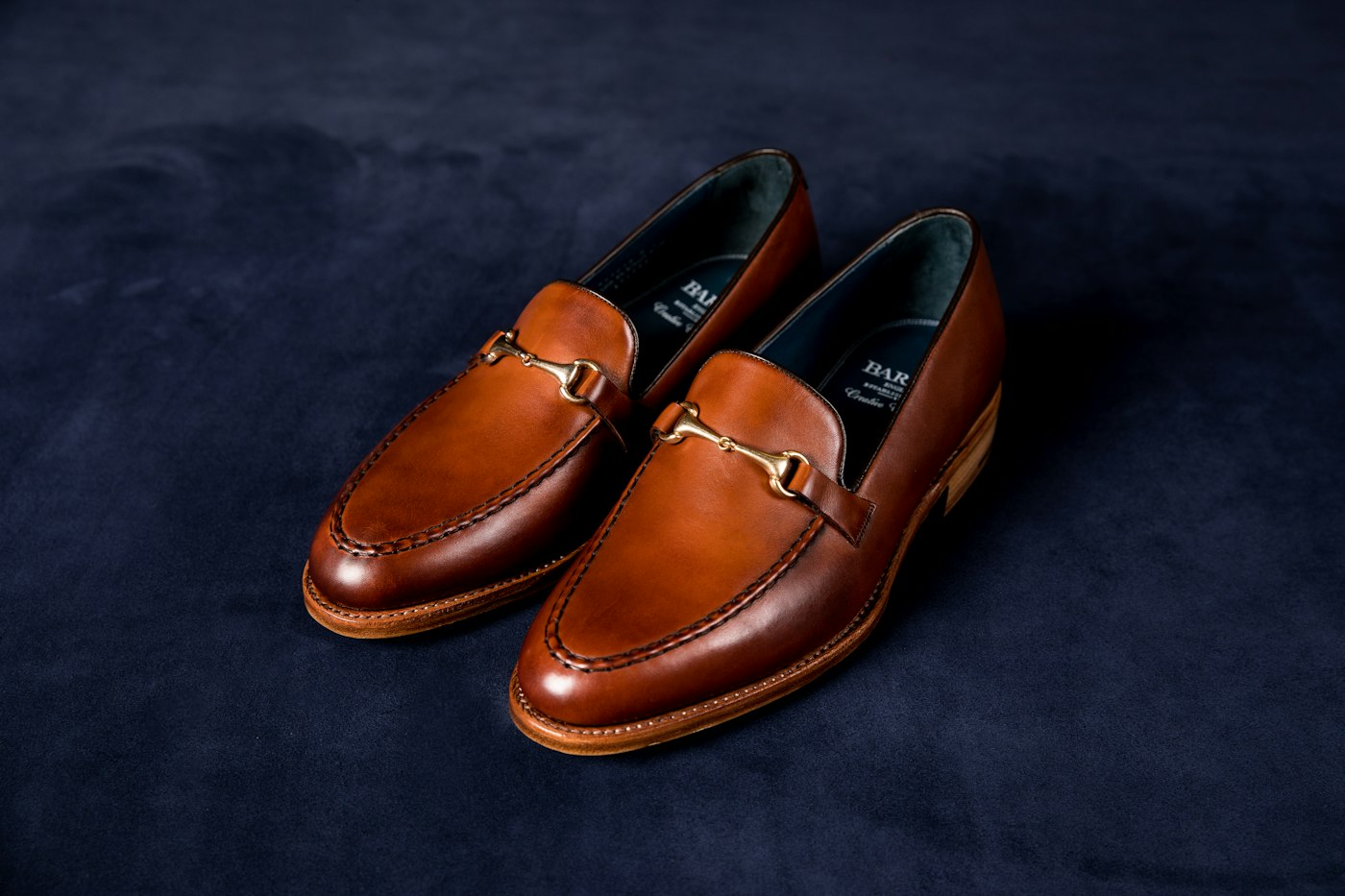 Brown leather loafers on blue textile