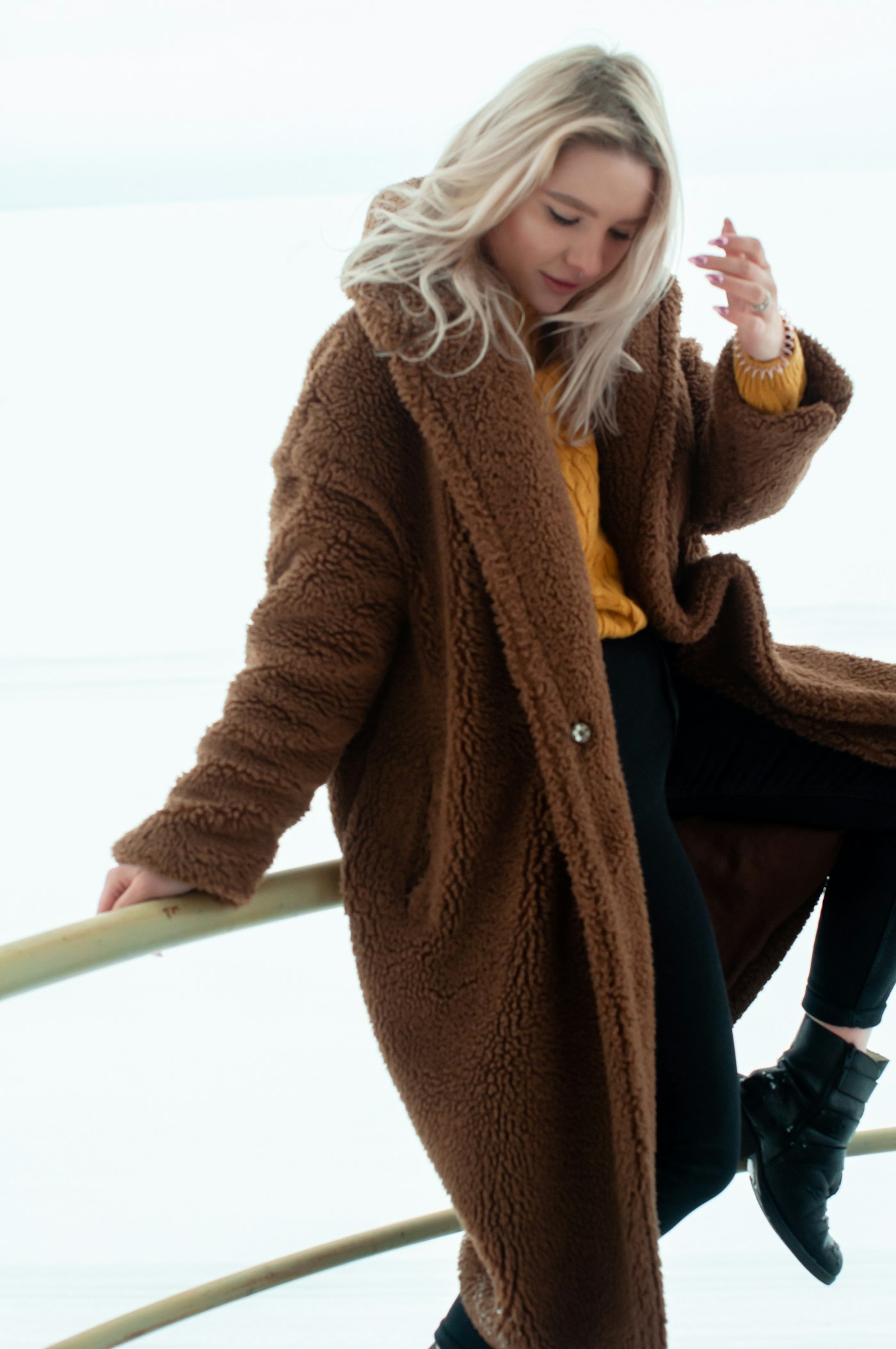 Woman standing while wearing a pink coat