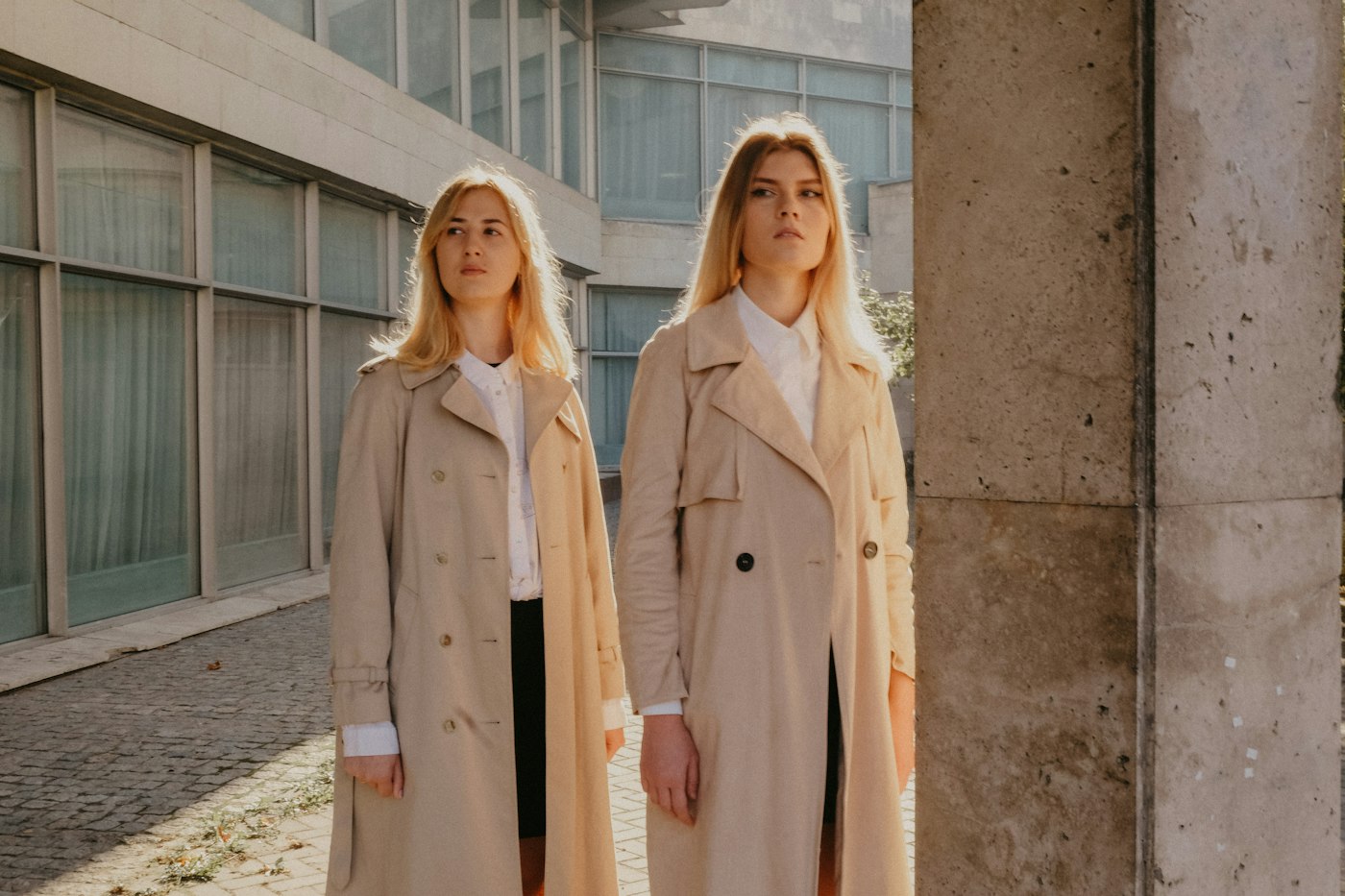 Two women wearing brown coats