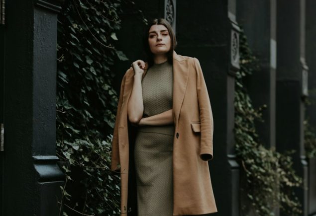 Neutral outfit graphic with a camel coat and olive skirt for a cropped jacket and trousers styling guide