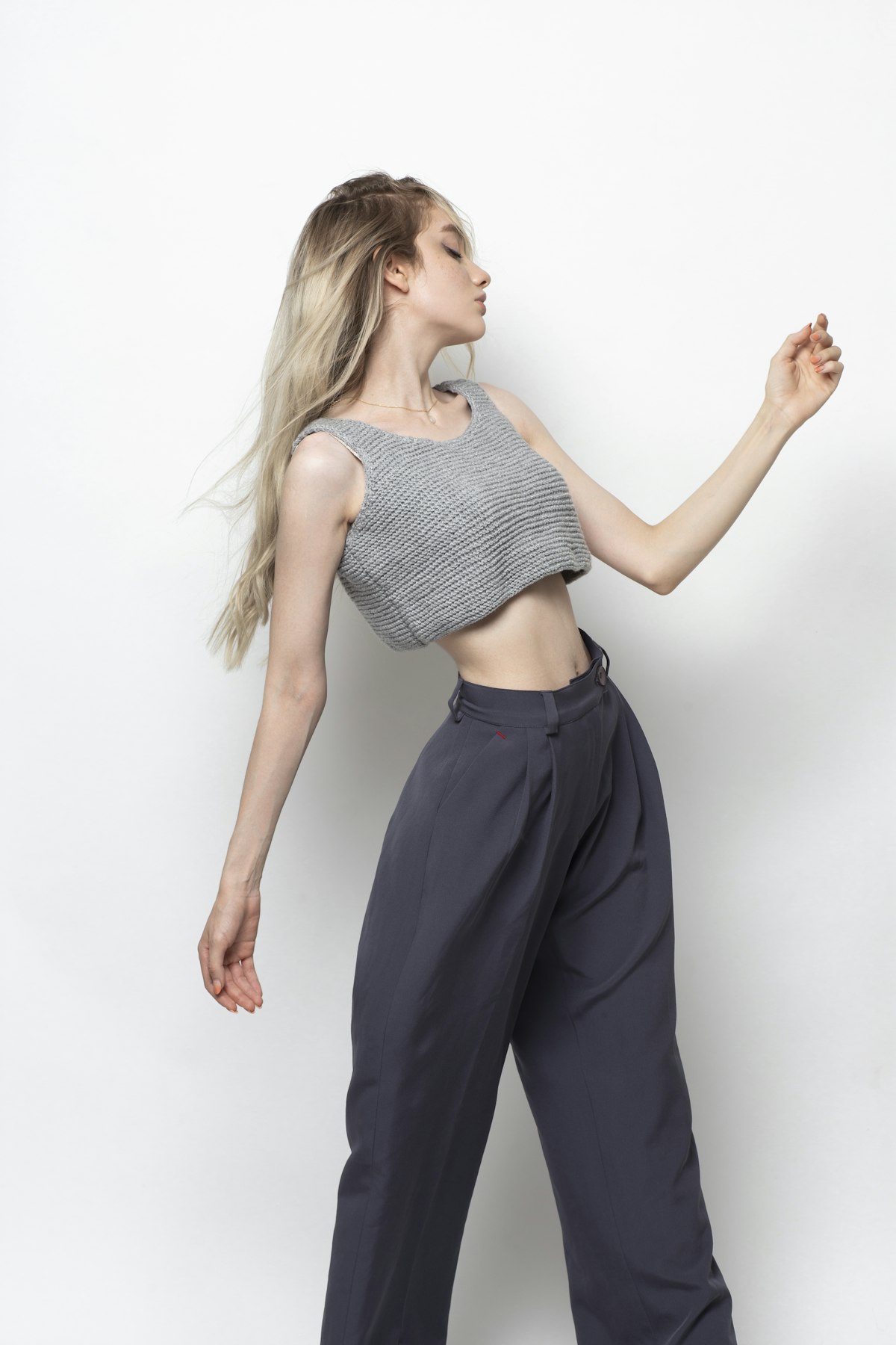 Woman in a grey top and black trousers