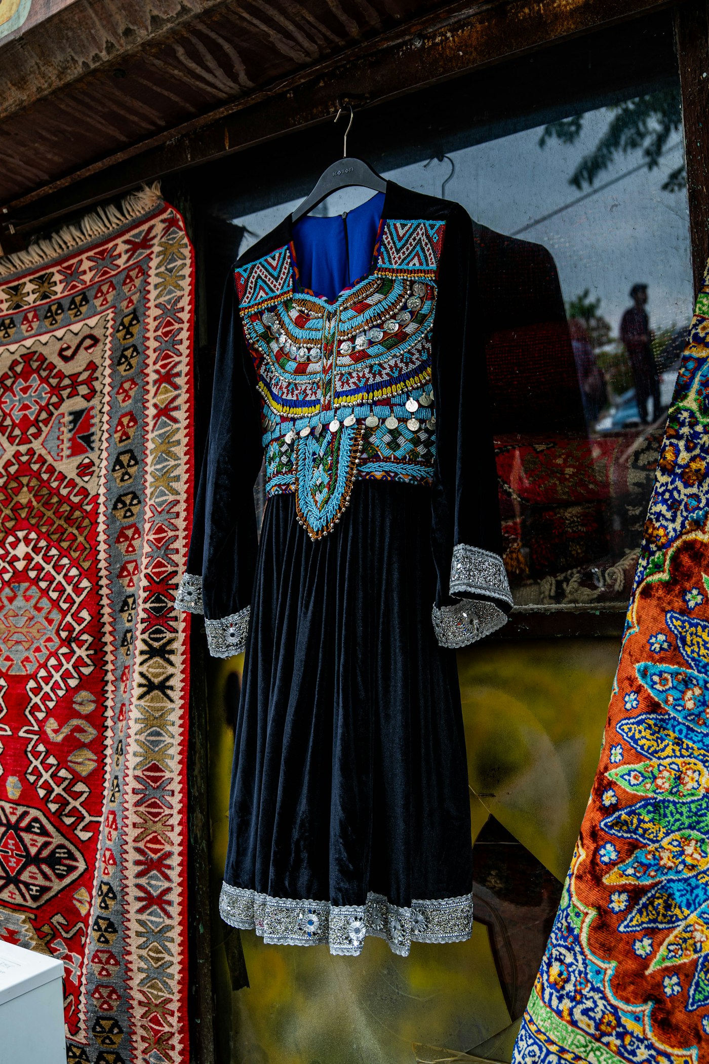 Ornate black dress with colorful embroidery and silver trim