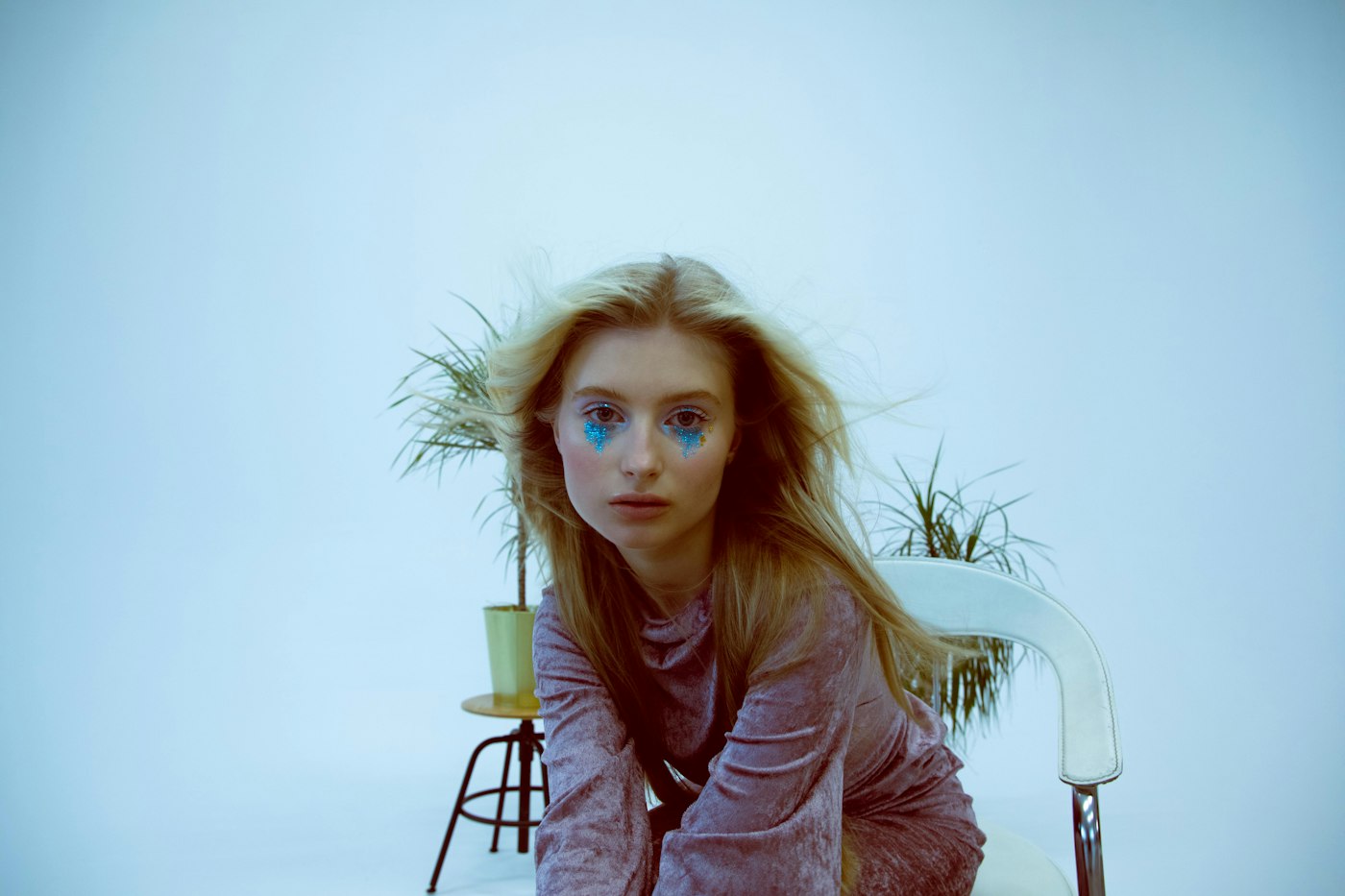 Woman in a purple dress with sparkling blue eye makeup