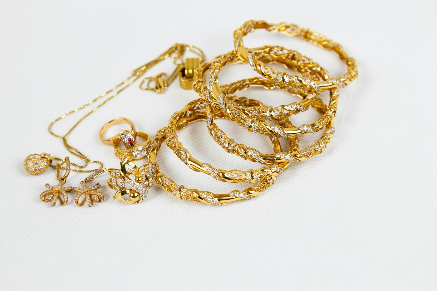 Gold chain necklace laid on a white surface