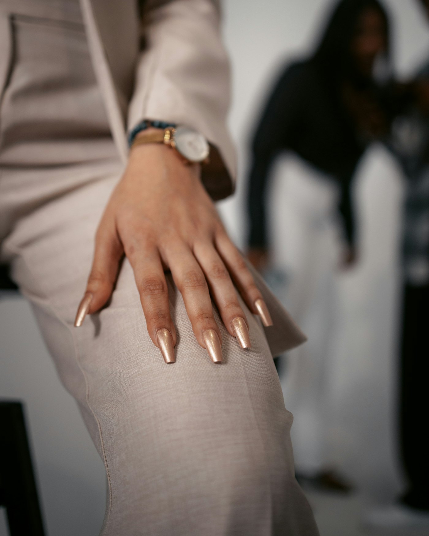 Woman hand with gold nails and a watch