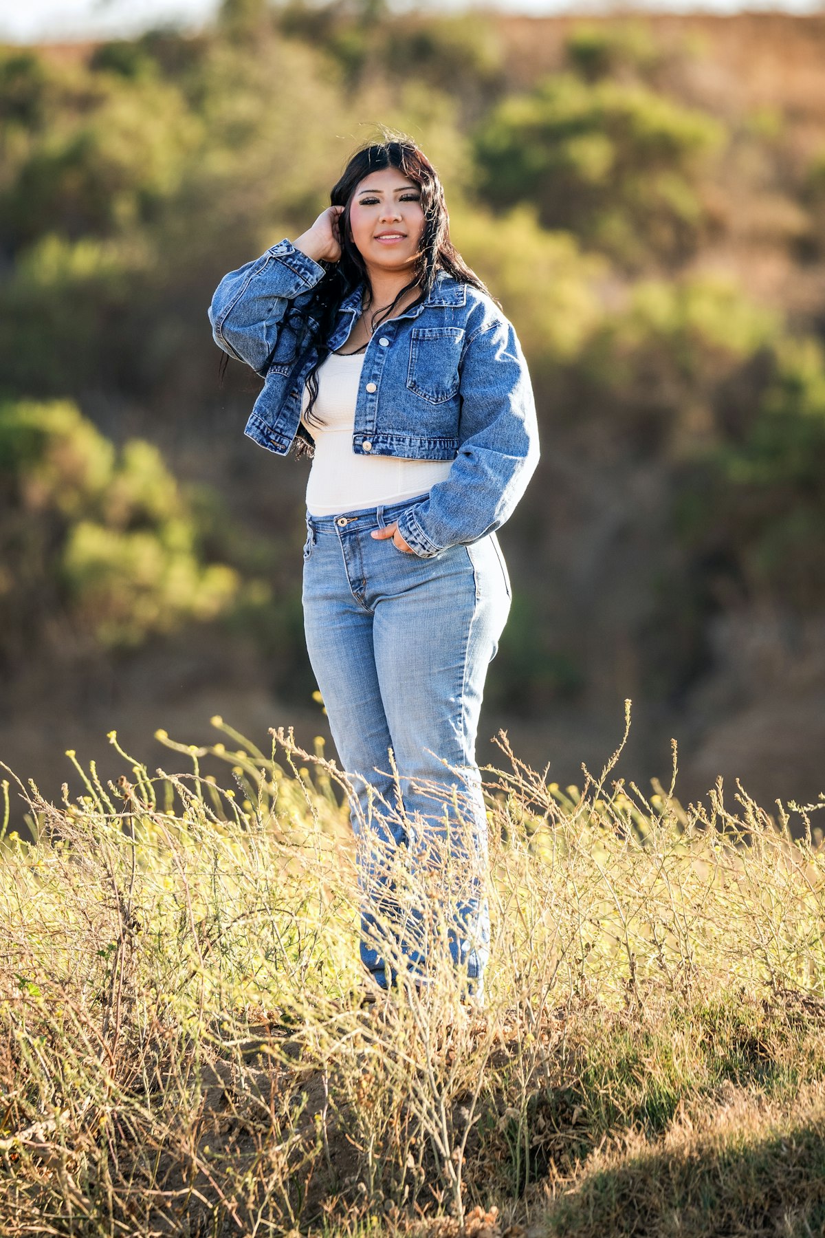 Young woman posing outdoors in a classic blue denim outfit