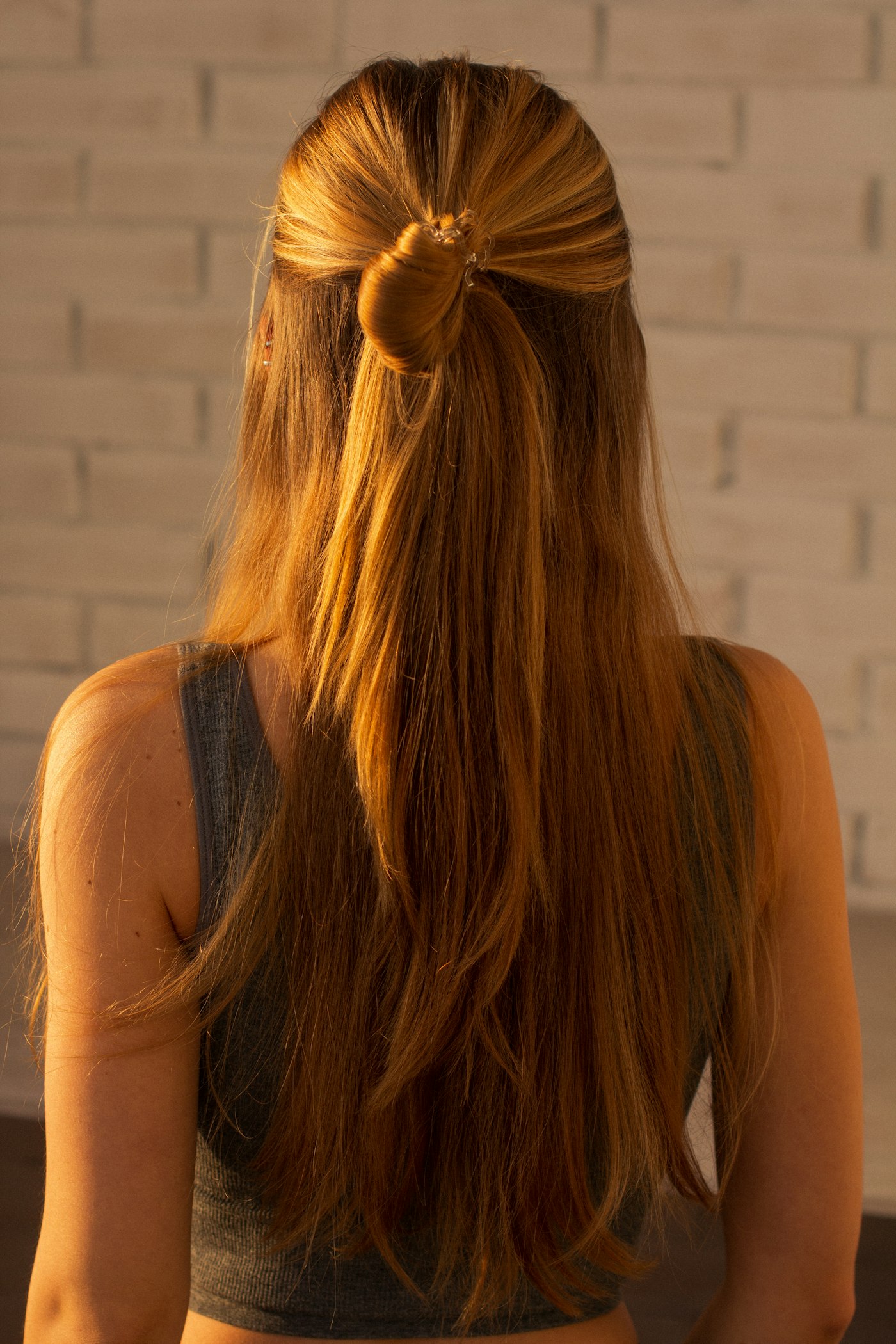 Woman with her hair half pulled back with a hair tie