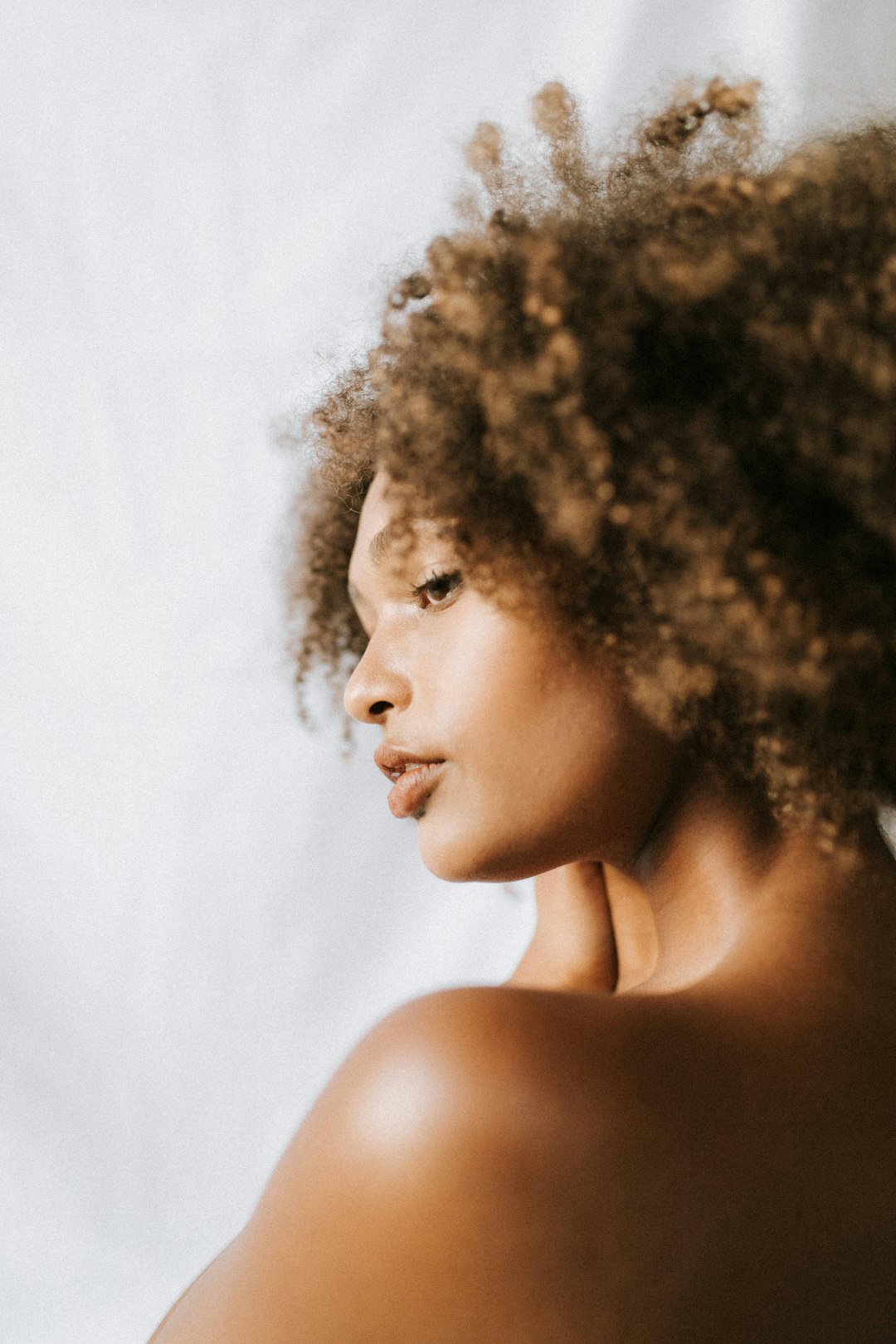 Woman with fresh glowing skin looking to the side