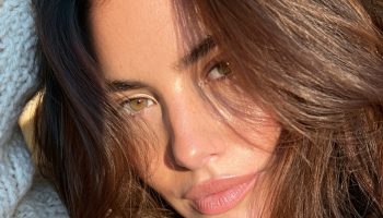 Woman with rich hot cocoa brown soft waves wearing a cream knit sweater