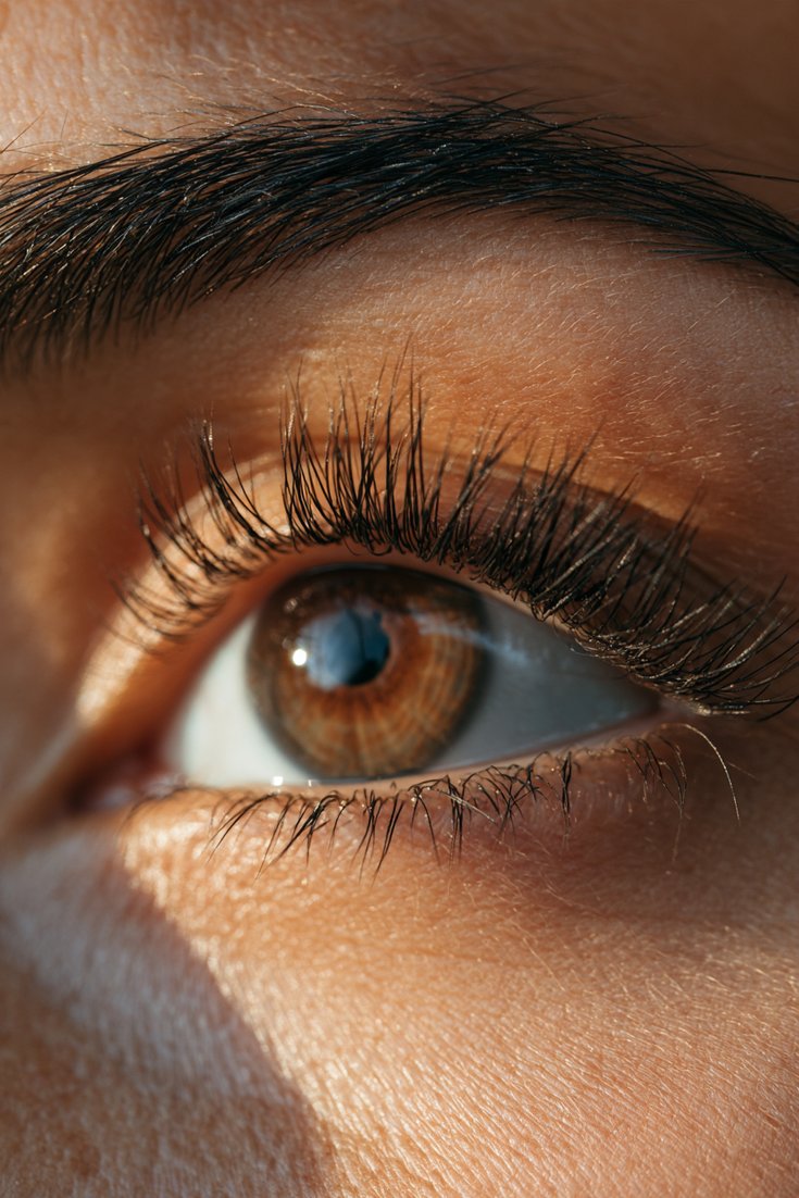 Close-up of a natural eye with classic one-to-one lash extensions, neat and defined