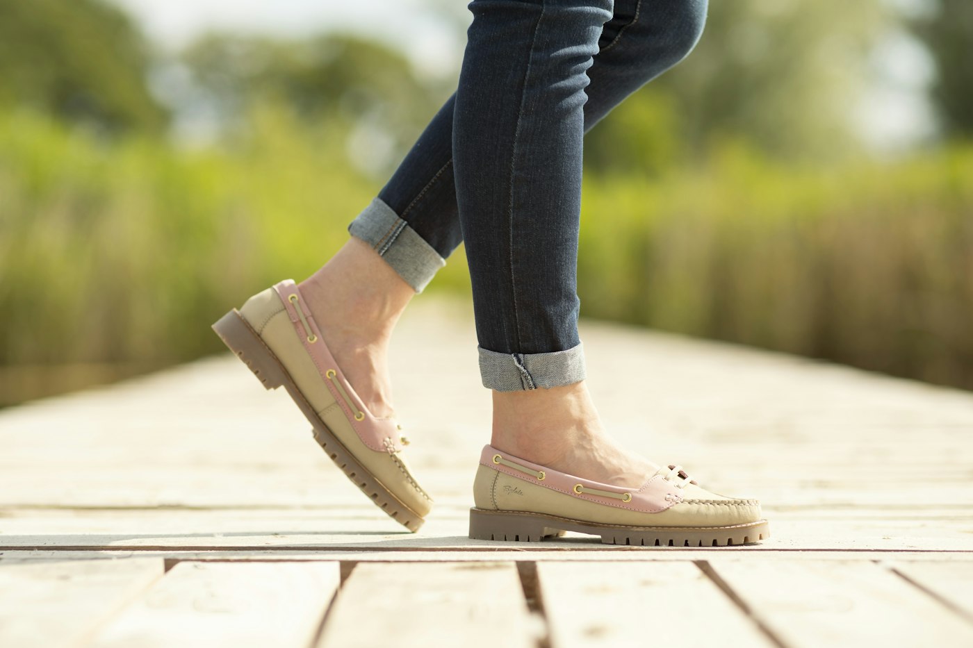 Person walking on a wooden platform in a park