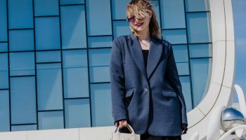 Woman in a blue blazer and sunglasses, soft tailoring look