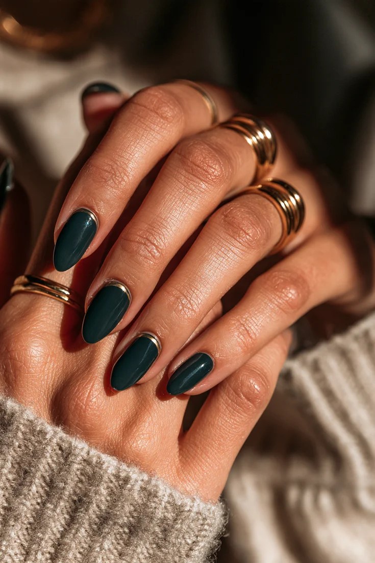 Forest green nails with a gold cuff accent, November nail idea