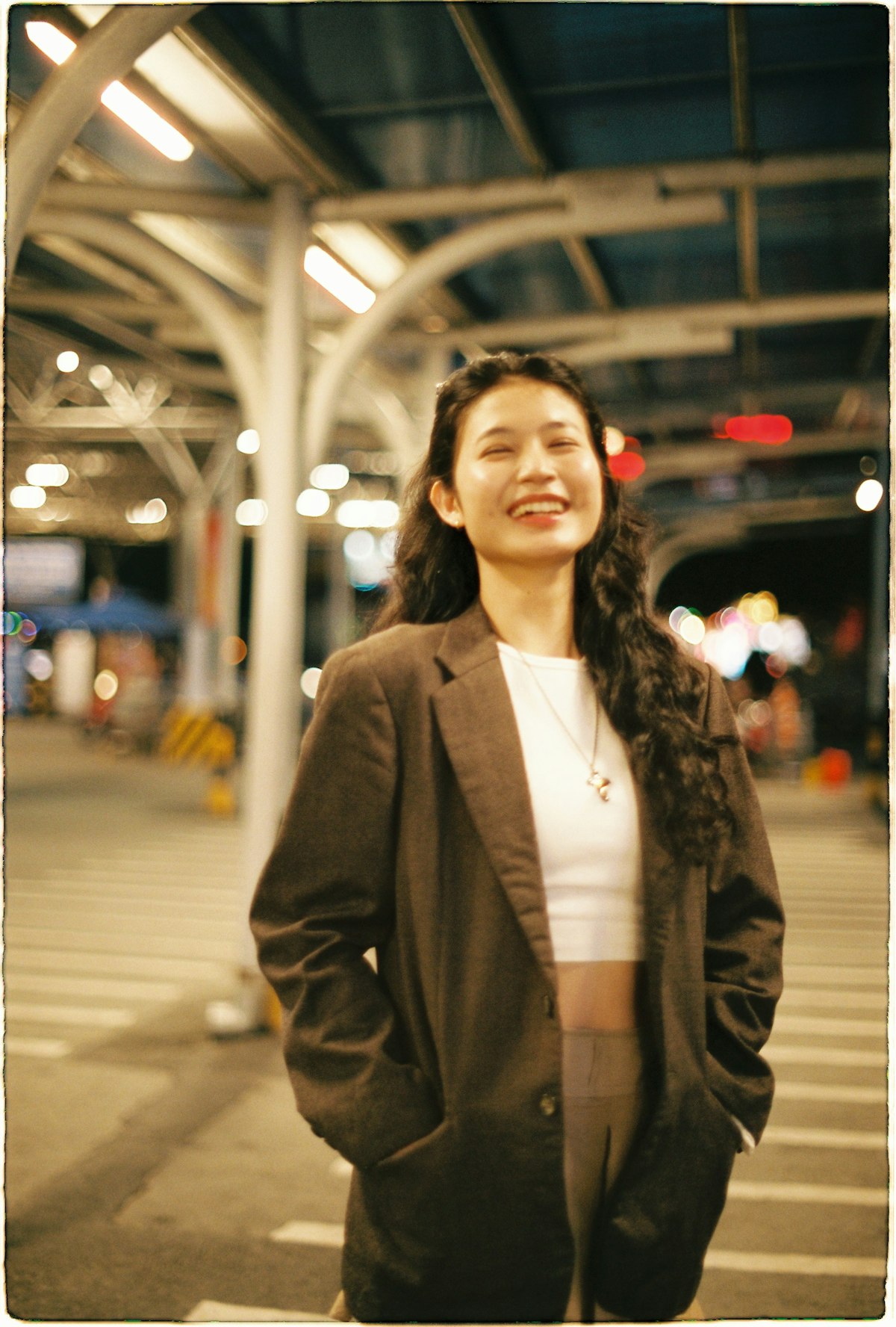 Young woman in a brown blazer smiling