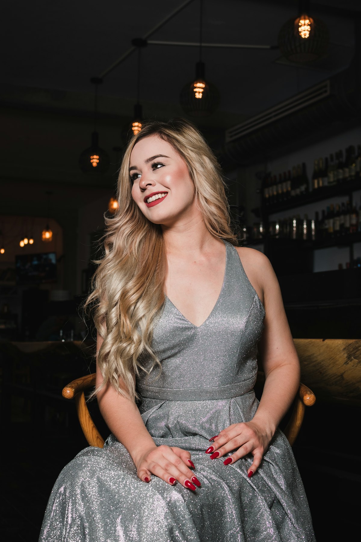 Young woman in a sparkly silver dress at a party