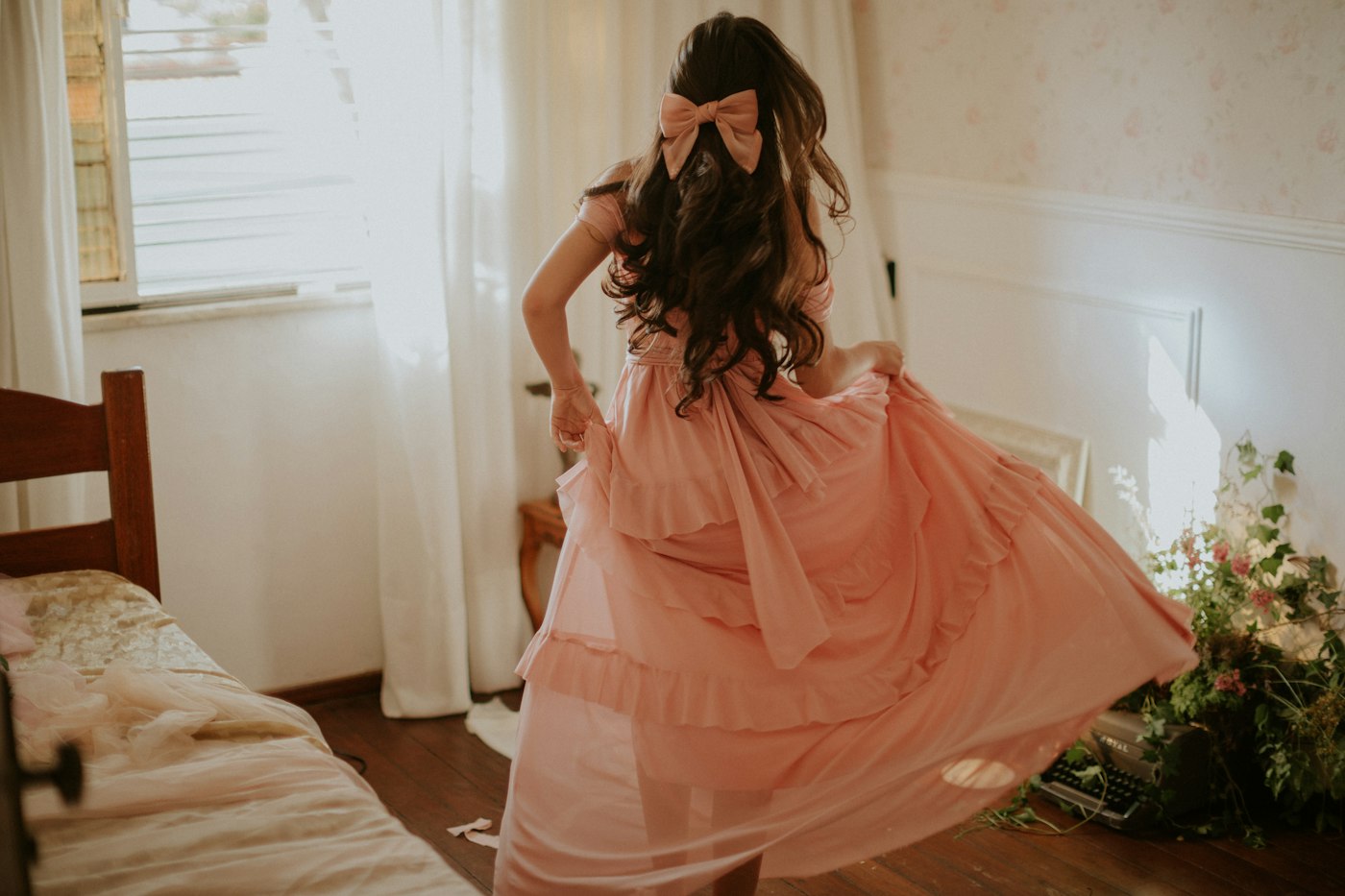 Woman in a pink dress standing indoors