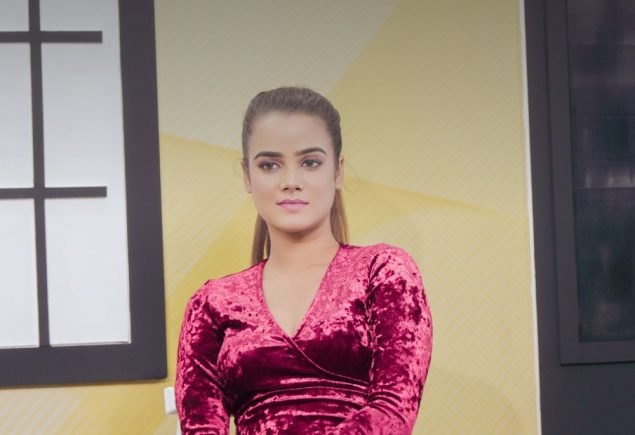 Woman in a pink dress sitting on a chair