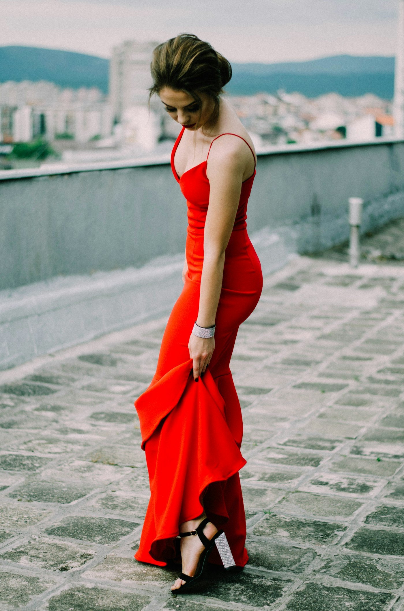 Woman wearing a bright red dress with thin straps