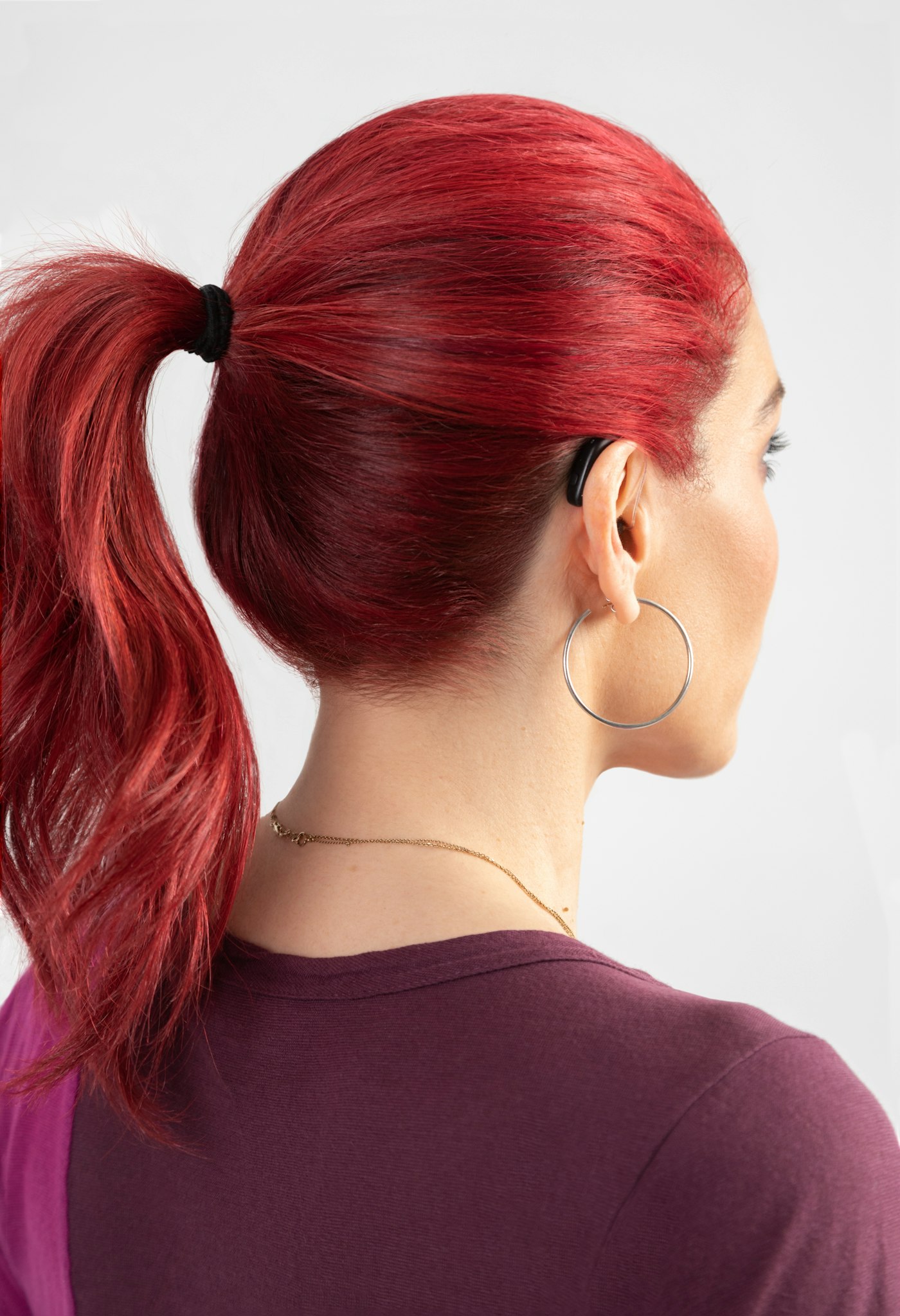 Woman with red hair wearing a ponytail
