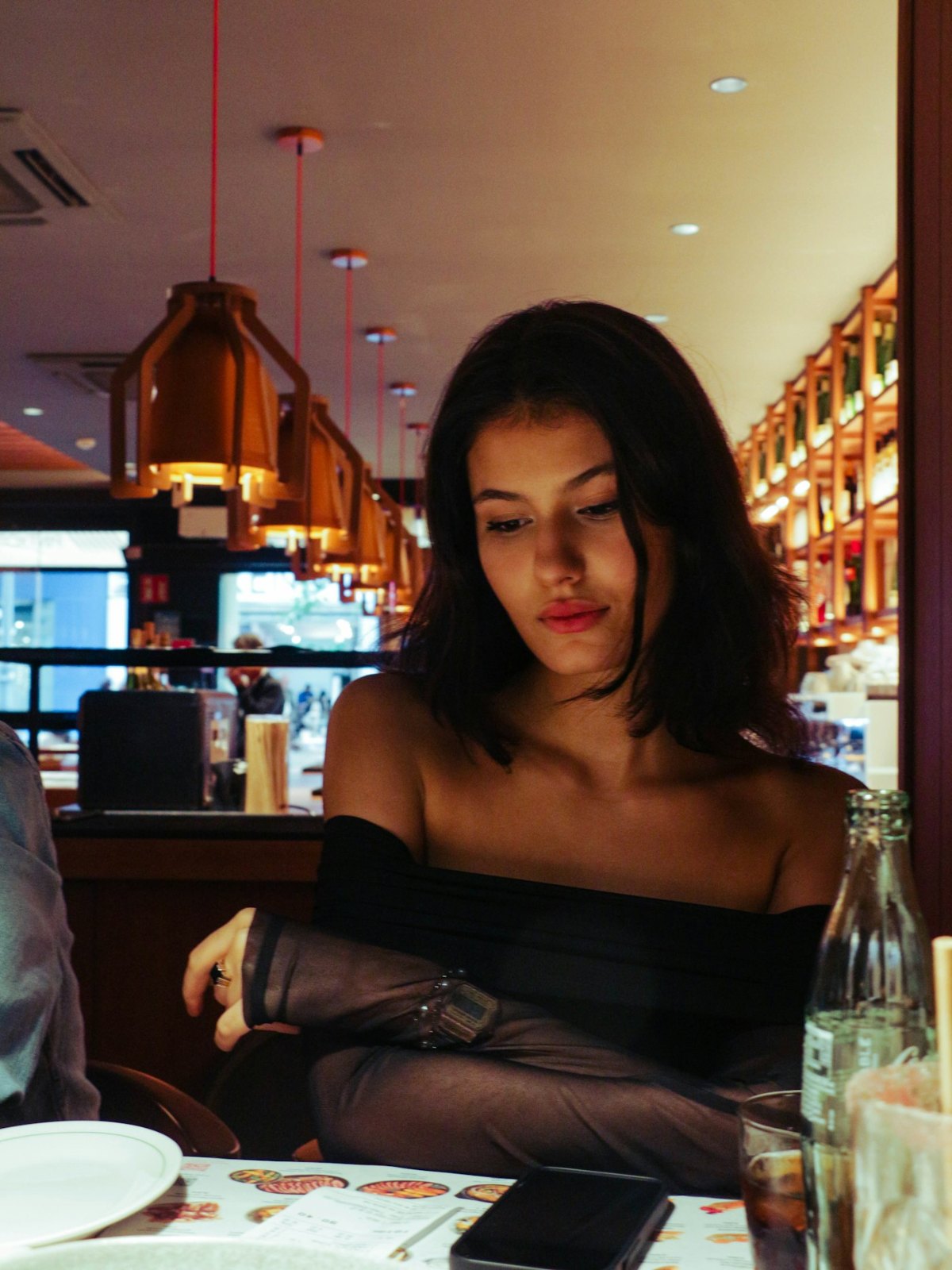 Young woman sitting at a table in a restaurant