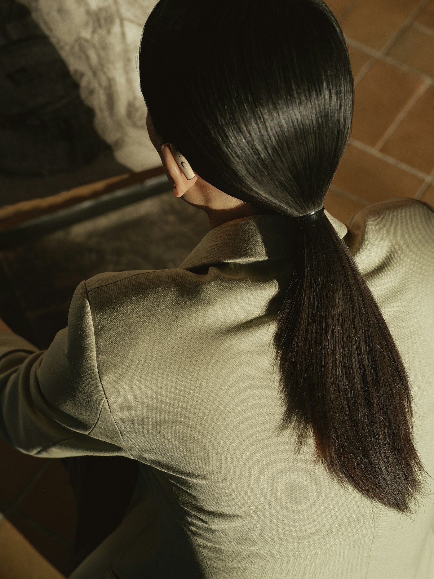 Woman with dark hair pulled back in a sleek ponytail